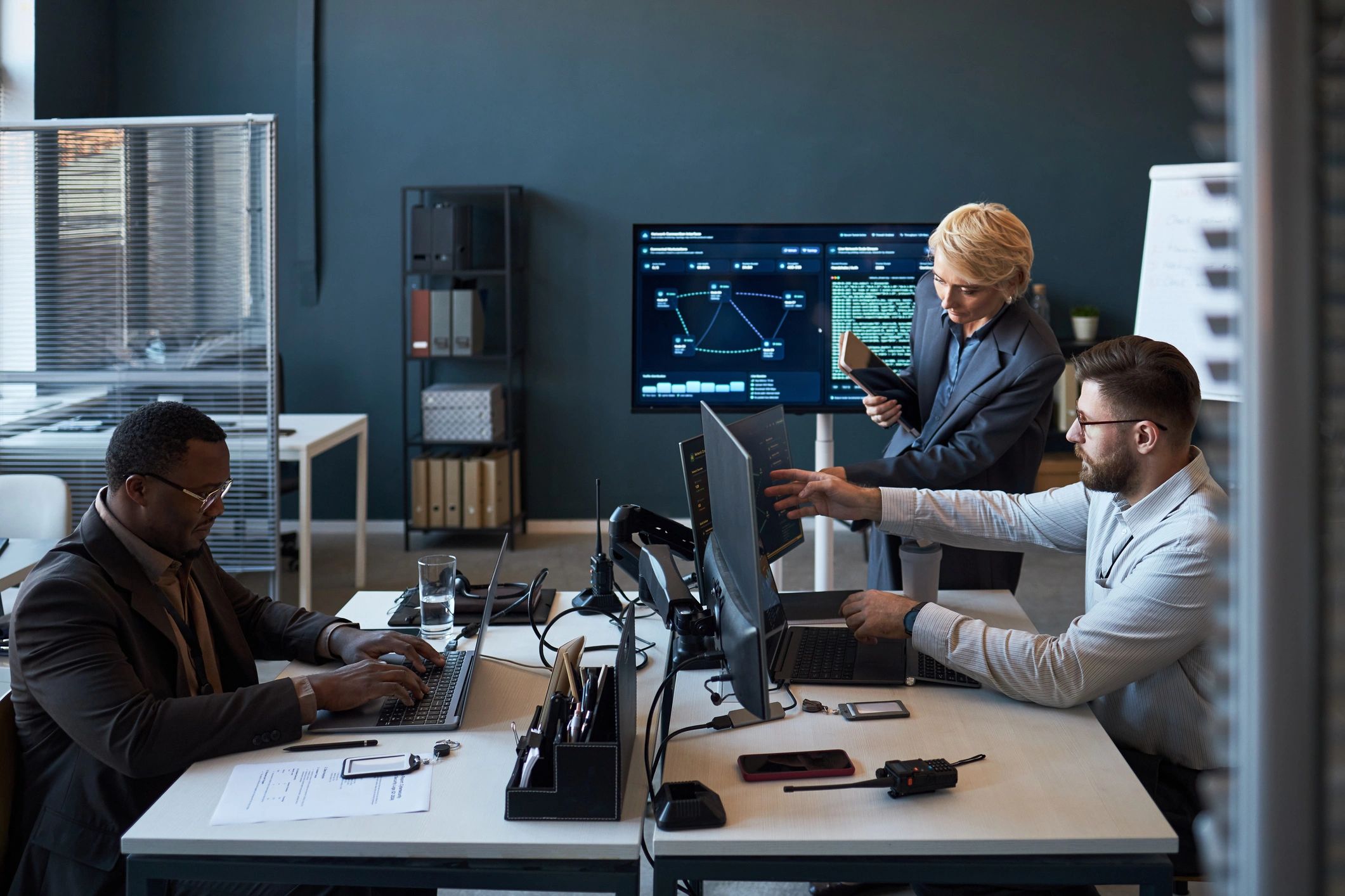 Consulting team reviewing dashboards and performance data in an office